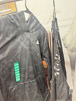 Adidas hoodie, charcoal sleeveless knit, light grey knit partially visible