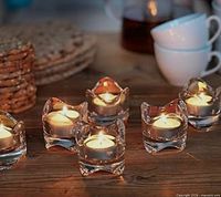 Group of lit Väsnas tealight holders on tabletop