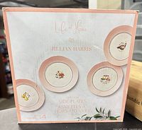 Front of sealed box showing product name and images of the four plates