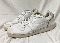 Left and right Nike white sneakers profile view