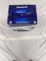 Top view of Panasonic SD-YD250 bread maker box with wear