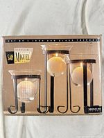 Retail box showing image of the three iron and glass candle holders