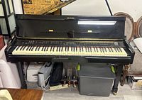 Front view of Suzuki digital baby grand piano showing keyboard and control panel