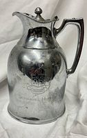 Front view showing engraved crest and overall form of pitcher