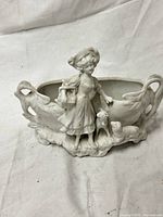 Front view showing full figurine, bowl and base detail