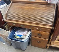 Front view of roll-top desk closed showing drawers and hardware