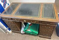 Full view of desk showing leather top, drawers, overall wear