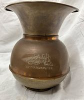 Front view showing embossed locomotive logo and patina