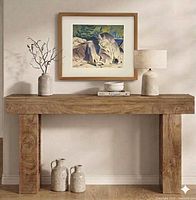 Framed lithograph displayed on wall above console table