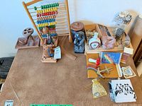 Overview of tabletop showing abacus, figurines, book, pipe stand and assorted decor