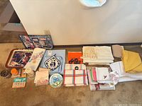 Overview of all linens, trays, napkin rings, candles and small items laid out