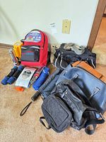 Group shot showing all bags, emergency kit, weights, umbrellas, flashlights
