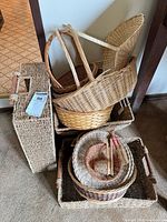 Stack of assorted wicker, rattan and seagrass baskets and trays