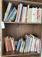 Two shelves filled with cookbooks and magazines