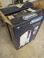 Two De'Longhi heater boxes, damaged tops visible