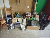 Wide view: boots, planters, shoes, twine, fruit picker, box of accessories