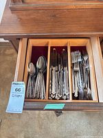 Drawer view showing grouped dinner forks, knives and spoons