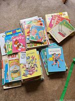 Three stacks of assorted vintage children’s books showing variety and visible titles