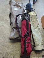 Overview of beige cart bag, red carry bag and grey travel case