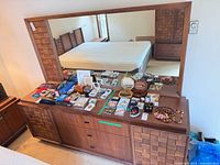 dresser with mirror showing front and accessories on top