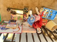 Entire lot on floor including plush, doctor kit, lamp, books, toys