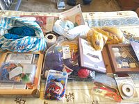overview of mixed yarn, kits, notions on bed