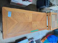 Top view of rectangular coffee table, shows veneer pattern, light brown finish and size scale