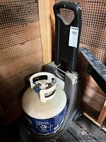 Propane tank dolly cart holding a 20 lb cylinder for scale