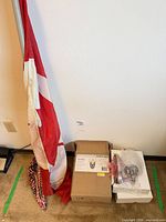 Flag, sconce box and bubble-wrapped fixture on floor
