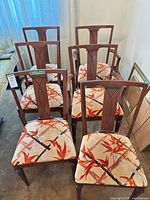 Six walnut-finished dining chairs with patterned seats