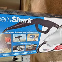 Retail box showing SteamShark handheld steam cleaner