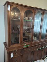 full front view of china cabinet showing glass doors and drawers