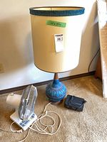 Lamp, fan and alarm clock grouped for scale