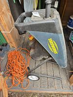 Full view of Yardworks shredder on stand with extension cord