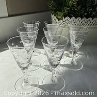 All eight Mikasa crystal liqueur glasses showing varied etched patterns