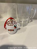 Full view of both items: glass mug and ornament