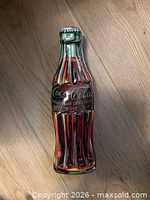Contour bottle shaped Coca-Cola tin