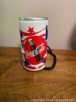 Front view showing Coca-Cola logo, patriotic design and strap
