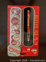 Blister pack with Coca-Cola pen and collector container discs