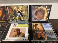 Close-up of four CDs showing Dixie Chicks, Shania Twain, Glen Campbell, Randy Travis