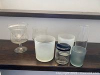Group shot of all glass containers on shelf