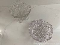 Cut glass footed bowl and oval crystal candy dish shown together