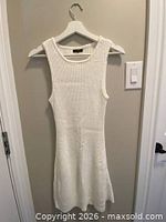 Front view of white ribbed sleeveless dress on hanger
