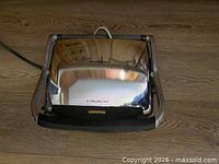 Closed Hamilton Beach panini press, exterior stainless steel lid