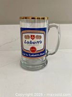 Front view of Labatt's Blue glass mug showing logo and gold rim