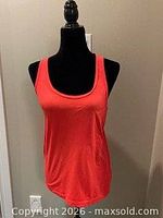 Front view of coral racerback tank top on mannequin