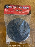 Front view of sealed tin in plastic with retail header card