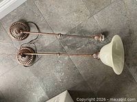 Two pendant fixtures laid out showing full rods, canopies, wiring and one shade attached