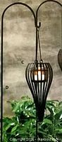 Lantern hanging on shepherd’s hook for scale