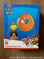 Front of boxed Paw Patrol kangaroo ball showing product image and child using it
